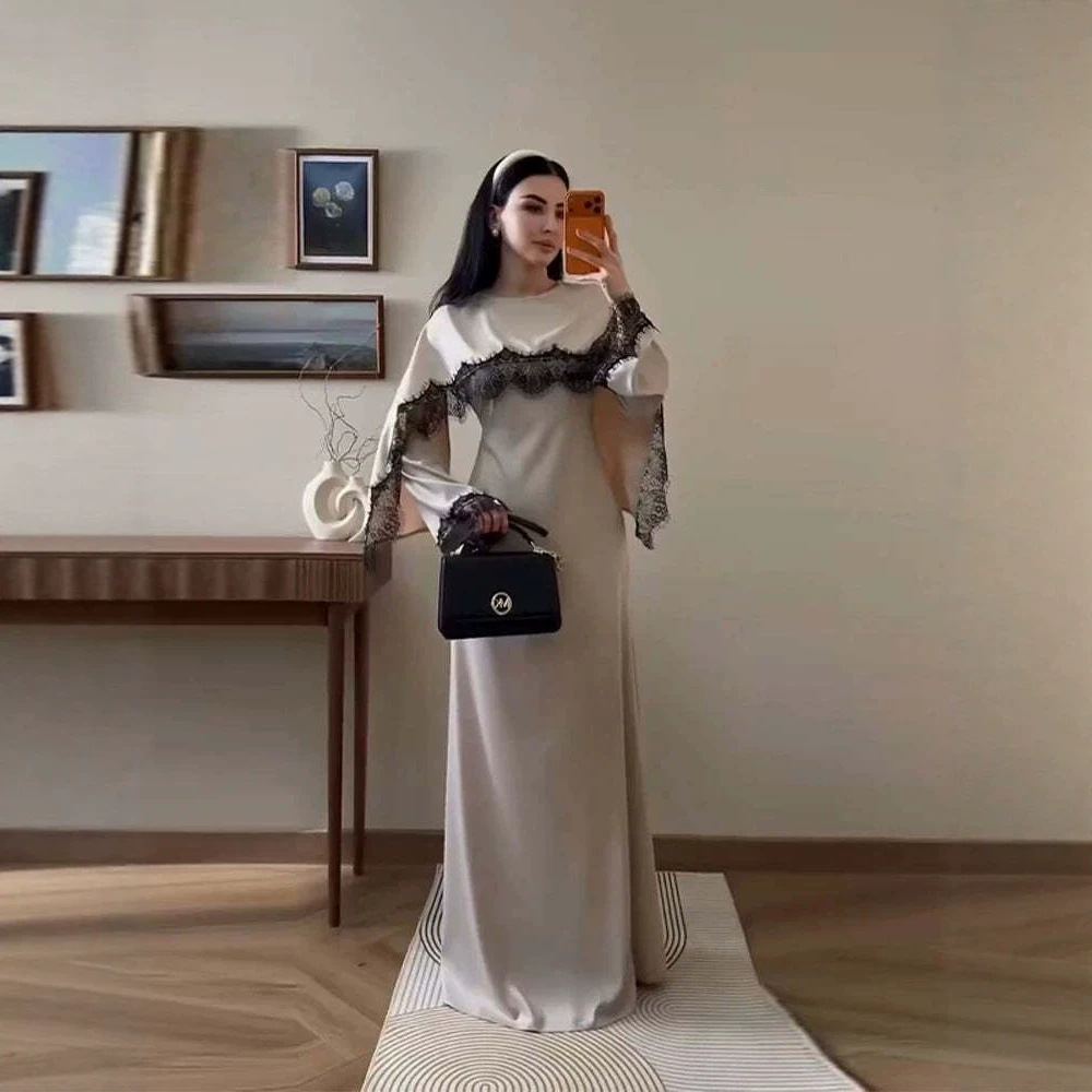 Model in a champagne lace-panel cape evening dress