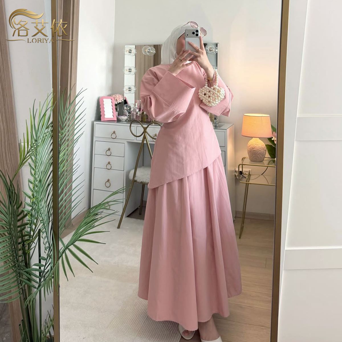 Model in a cream long-sleeve top with matching maxi skirt