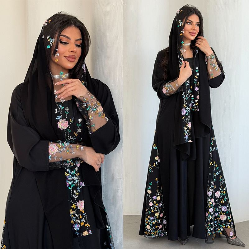 Model in black embroidered modest robe with floral beaded headwrap