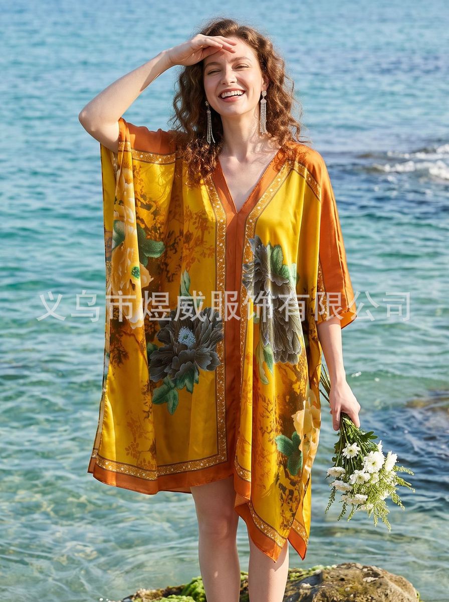 Plus-size V-neck kaftan maxi dress in black with gold feather print and orange edge