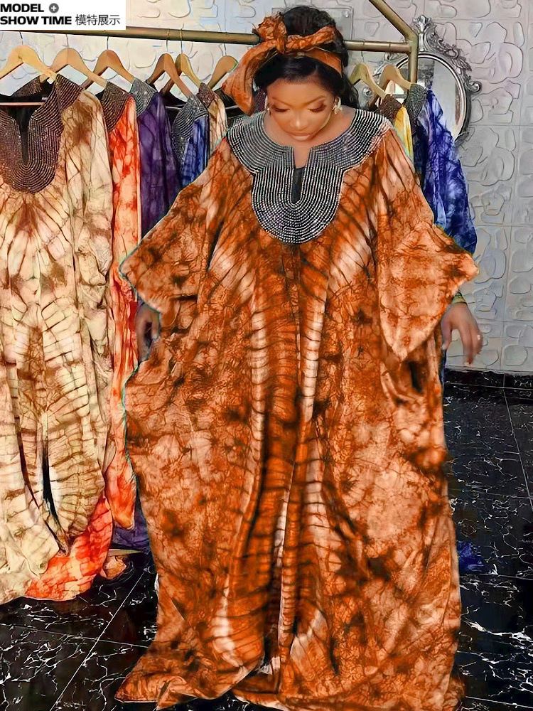 Warm-toned printed African boubou dress with beaded collar and headwrap
