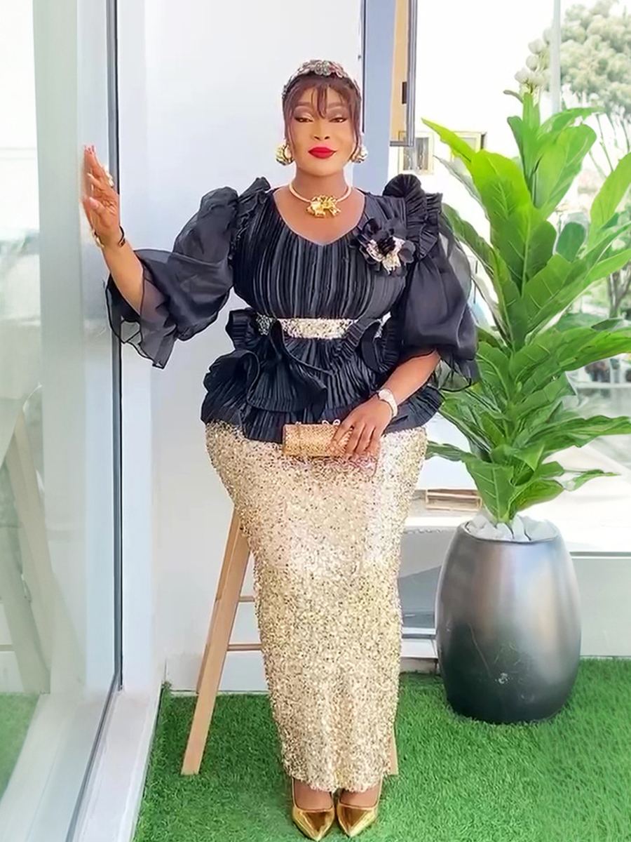 Black pleated V-neck top with gold sequin skirt evening set