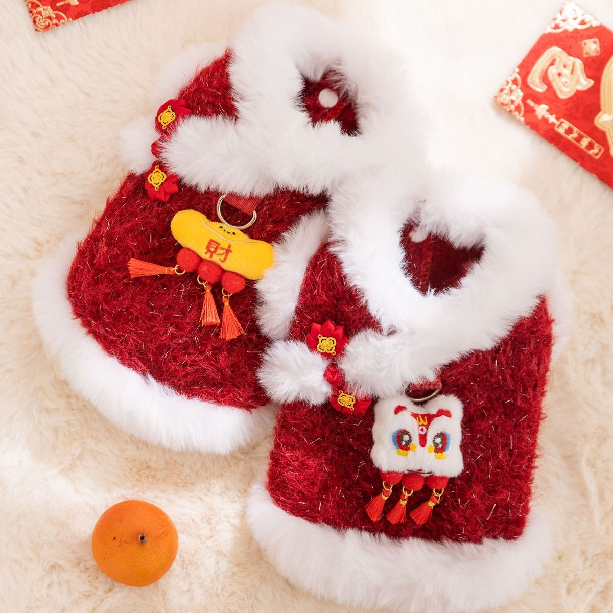 Two red Chinese New Year lion-themed fleece dog coats with festive decor